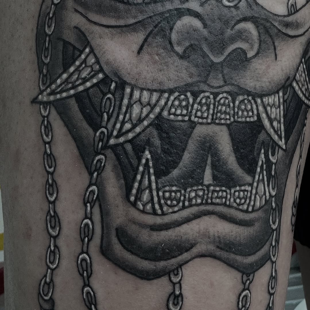 Hannya mask blackwork tattoo on arm